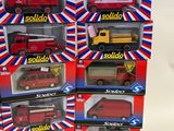 three red and yellow toy trucks are in a display box