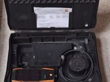 a black case with a tool in it on the floor