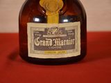 a bottle of grand marnier liquor on a red table