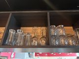 many glasses and glasses on the shelf in the kitchen