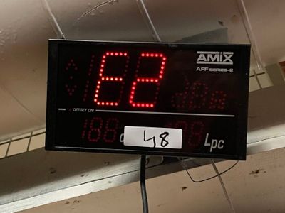 a digital clock on the ceiling of a building