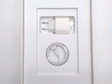 a white box with a charger and a cable in it