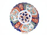 a plate with a flower design on it on a stand