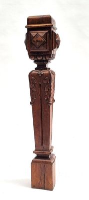 a wooden statue of a man with a hat on top of it