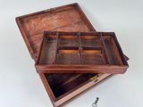 a small wooden box with a pair of scissors in it