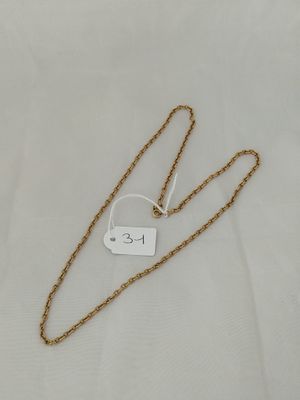 a close up of a gold chain with a tag on it