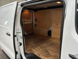 a white van with the door open in a building