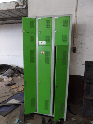two green lockers that are in a room