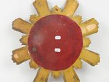 a red and yellow sunburst on a white surface