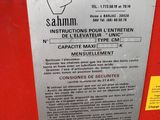 a sign on the side of a red machine that says sahm