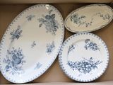 three plates in a box with blue flowers on them