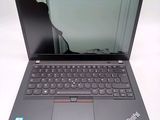 a laptop that is open on a white surface