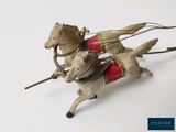 a toy horse pulling a carriage with a dog on it