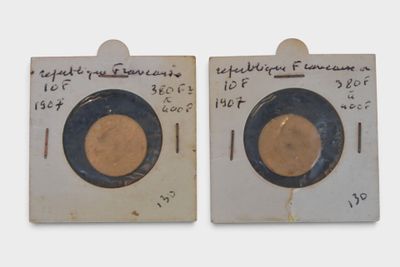 pair of antique brass plates with black rims and writing on them