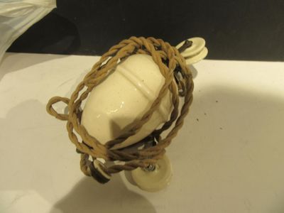 a white object with a rope wrapped around it on a counter
