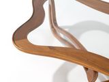 a wooden table with a glass top on a white surface