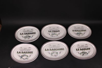 six tins of lip bales sitting on top of a black table