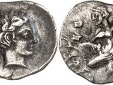 a silver coin with a woman and a man on it