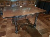 a table with a wooden top on a checkered floor