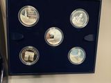a picture of a set of four coins in a display case