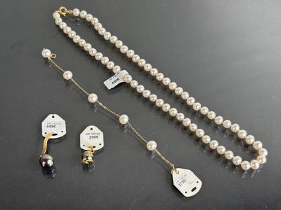 a close up of a necklace and a pair of scissors