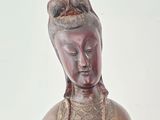 a statue of a woman holding a bowl of food