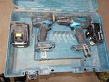 two power tools in a blue case on the floor