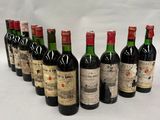 six bottles of wine lined up in a row on a white surface