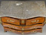 a marble top chest of drawers on display
