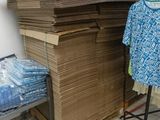 a pile of boxes and a chair in a room