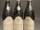 three bottles of wine sitting on top of a table next to each other