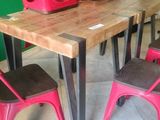 a wooden table with red chairs and a wooden table