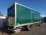 a green truck parked in a parking lot