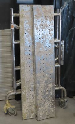 a metal rack with a bunch of pieces of metal on it