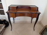 a small desk with a mirror on top of it