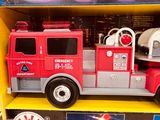 a toy fire truck that is in the box
