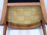 a wooden chair with a black cushion on it
