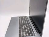 a silver laptop with a black keyboard on a white surface