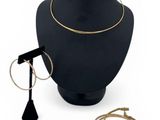 a close up of a necklace on a mannequin with other jewelry