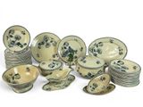 a lot of plates and bowls sitting on a table