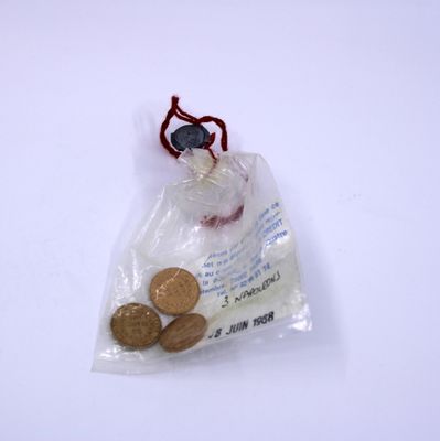 a bag of coins sitting on top of a white table