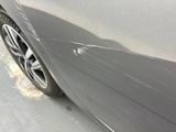 a close up of a car ' s paint job on the side of the road