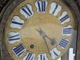 a clock that is sitting in a glass case
