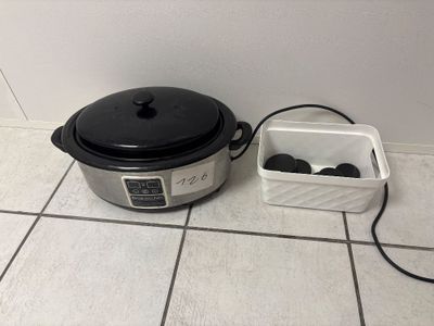 an image of a crock pot and a container on the floor