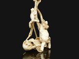 an antique carved ivory figurine of a man and woman on a boat