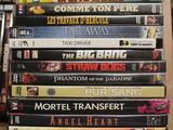 many dvds stacked on top of each other on a shelf
