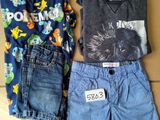 two pairs of shorts and a t - shirt are on the floor