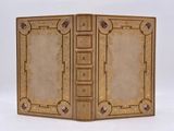 un vieux livre à la couverture dorée et ornée d'un motif décoratif