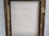 an old picture frame with peeling paint and a white background