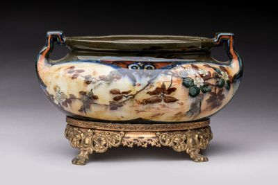 an image of a large vase with a handle on a stand